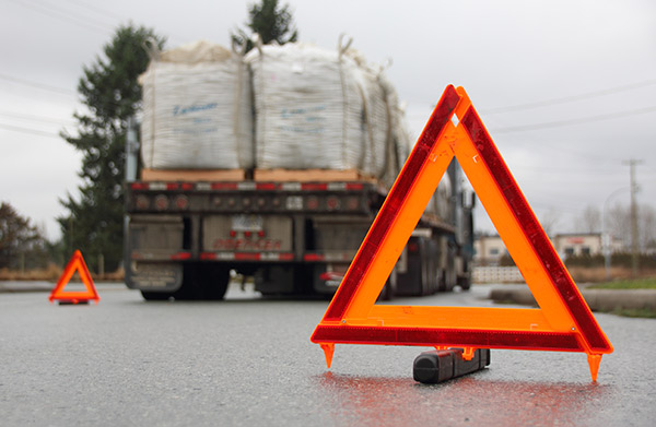 Semi-trailer with reflective warning triangles.